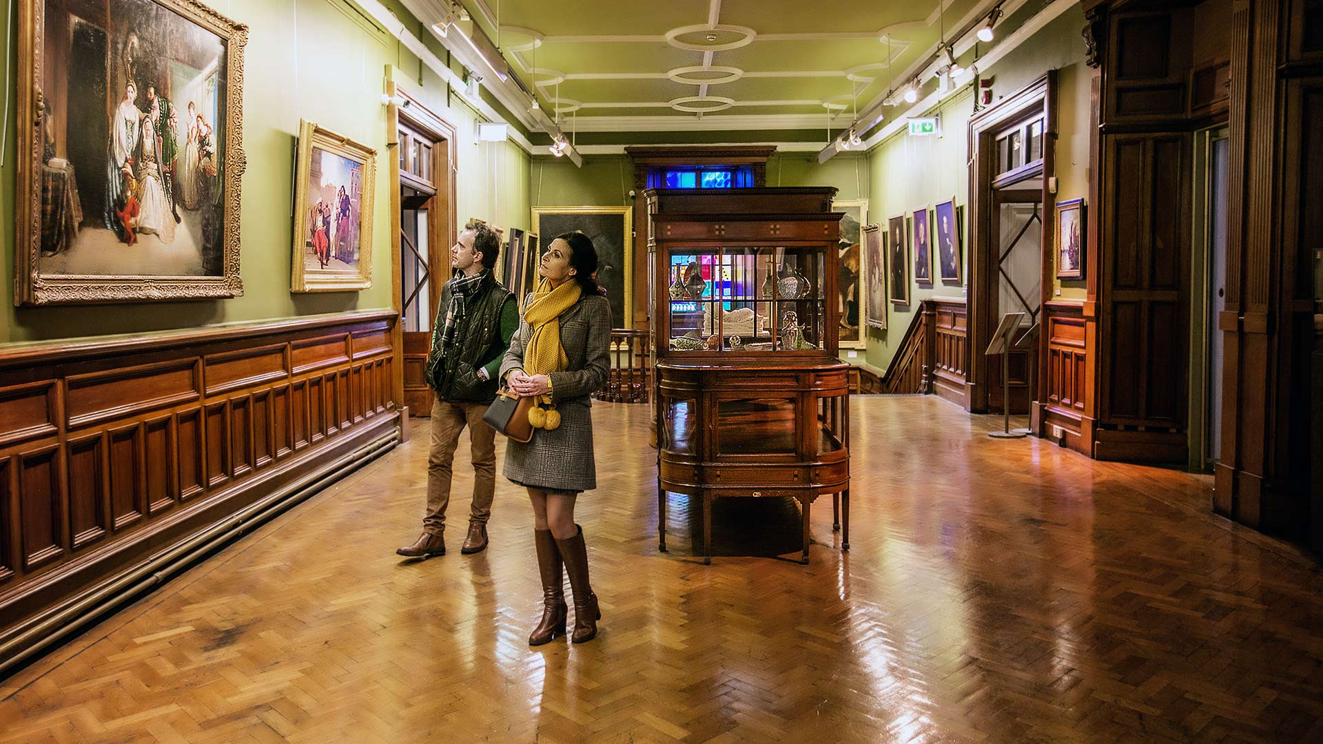 Two people browse the historical art collection at Crawford Art Gallery Cork