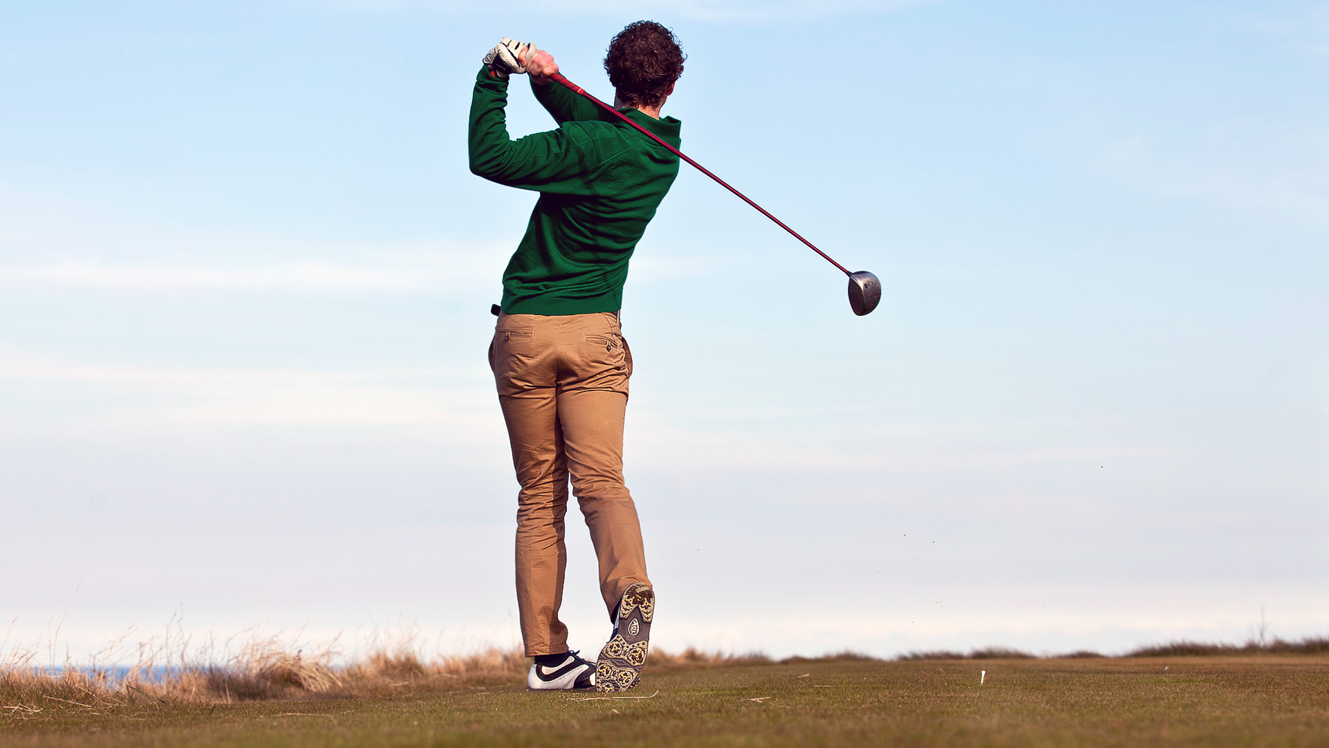 Man swinging a golf club