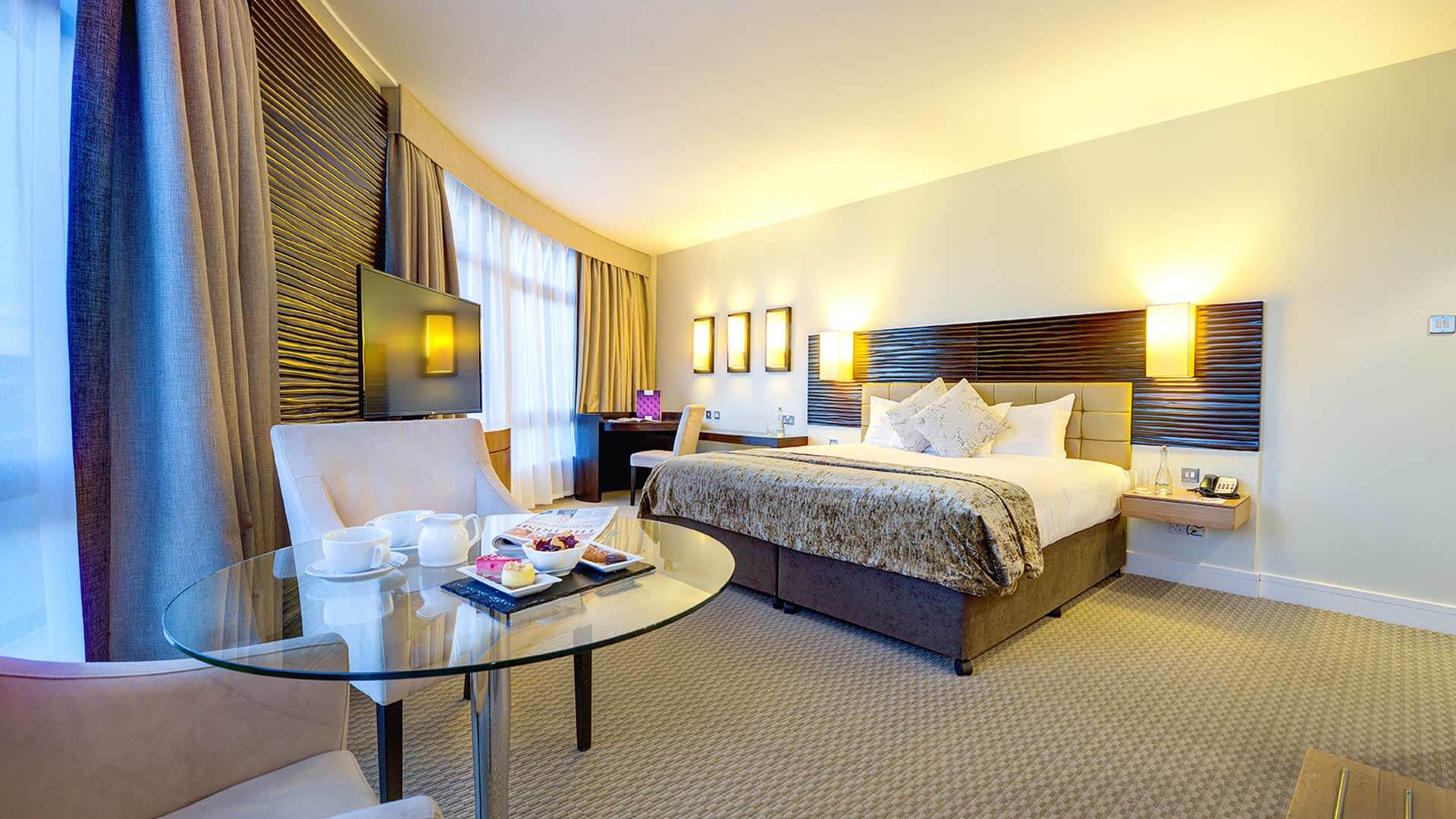 Deluxe Room at Cork International Hotel with king size bed, hot drinks and treats on a table