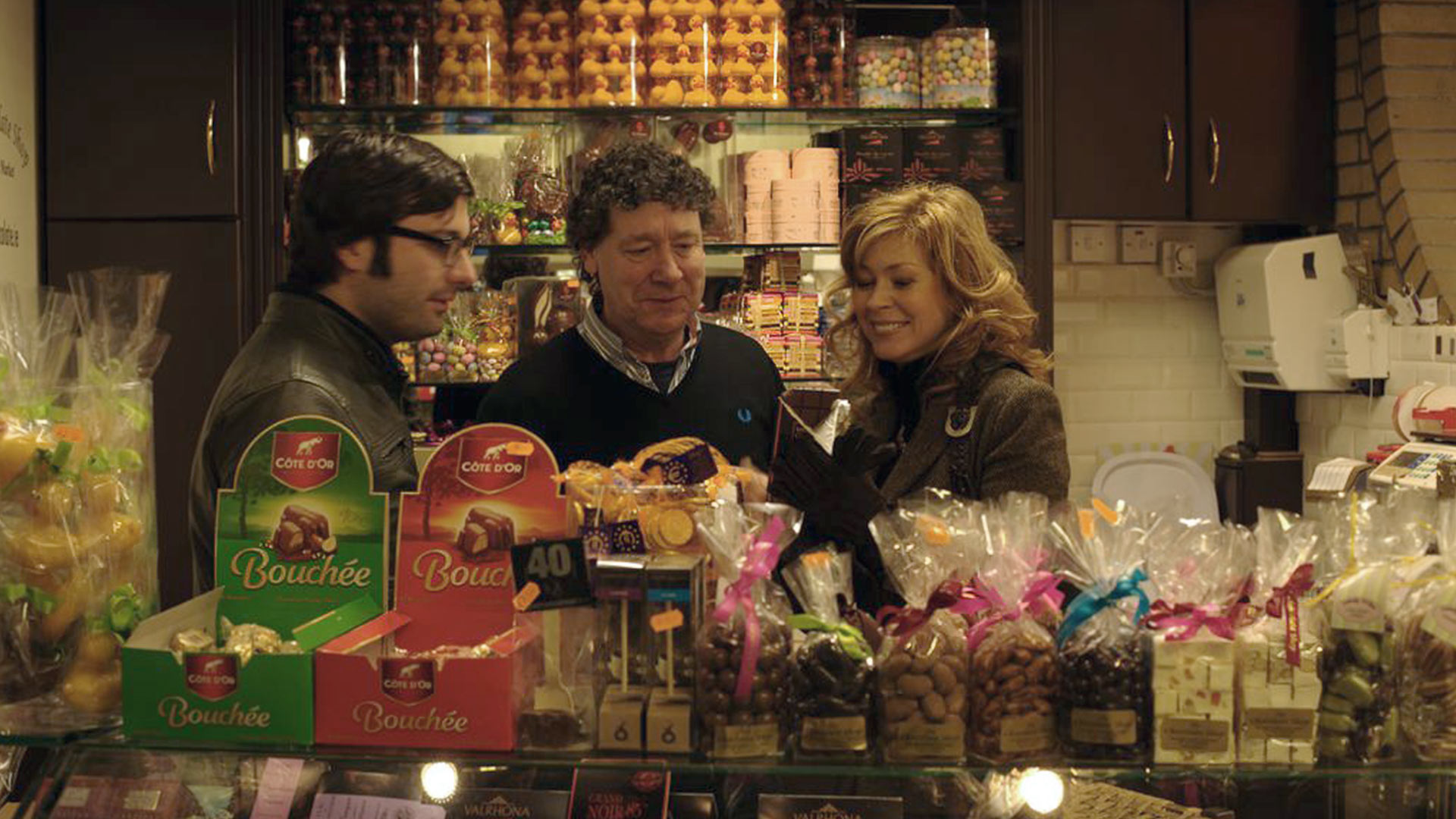 People at a sweet stall with an array of sweets and chocolates at the English Market