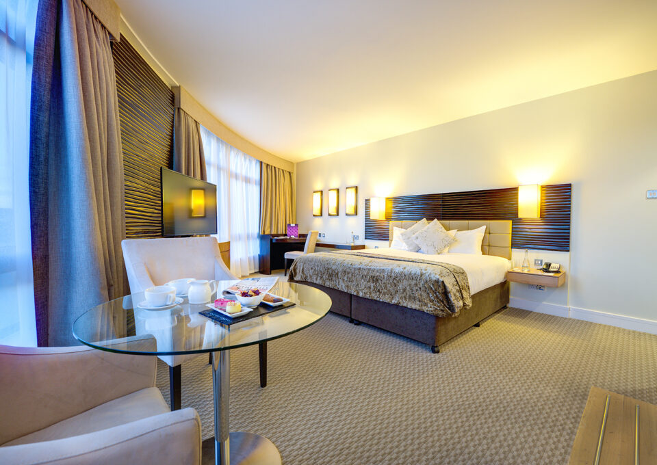 Image of spacious deluxe bedroom at Cork international Hotel