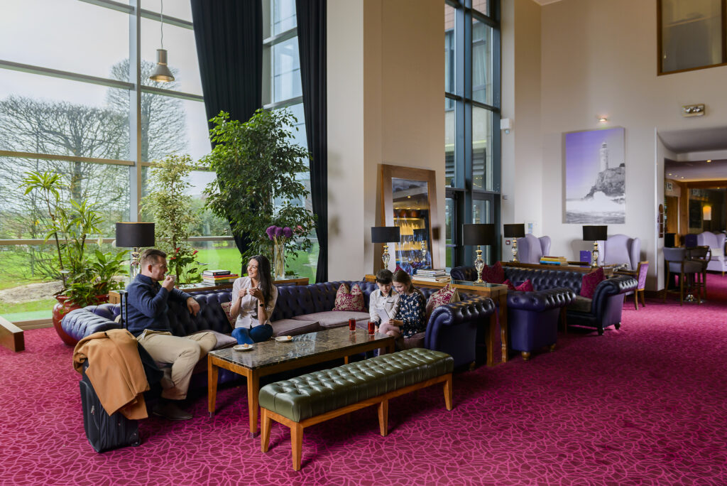 Image of family enjoying coffee in the Spacious Lobby at Cork Internional Hotel
